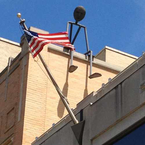photo of Man Sitting On Ledge at 2 West Main Street Madison WI 53703
